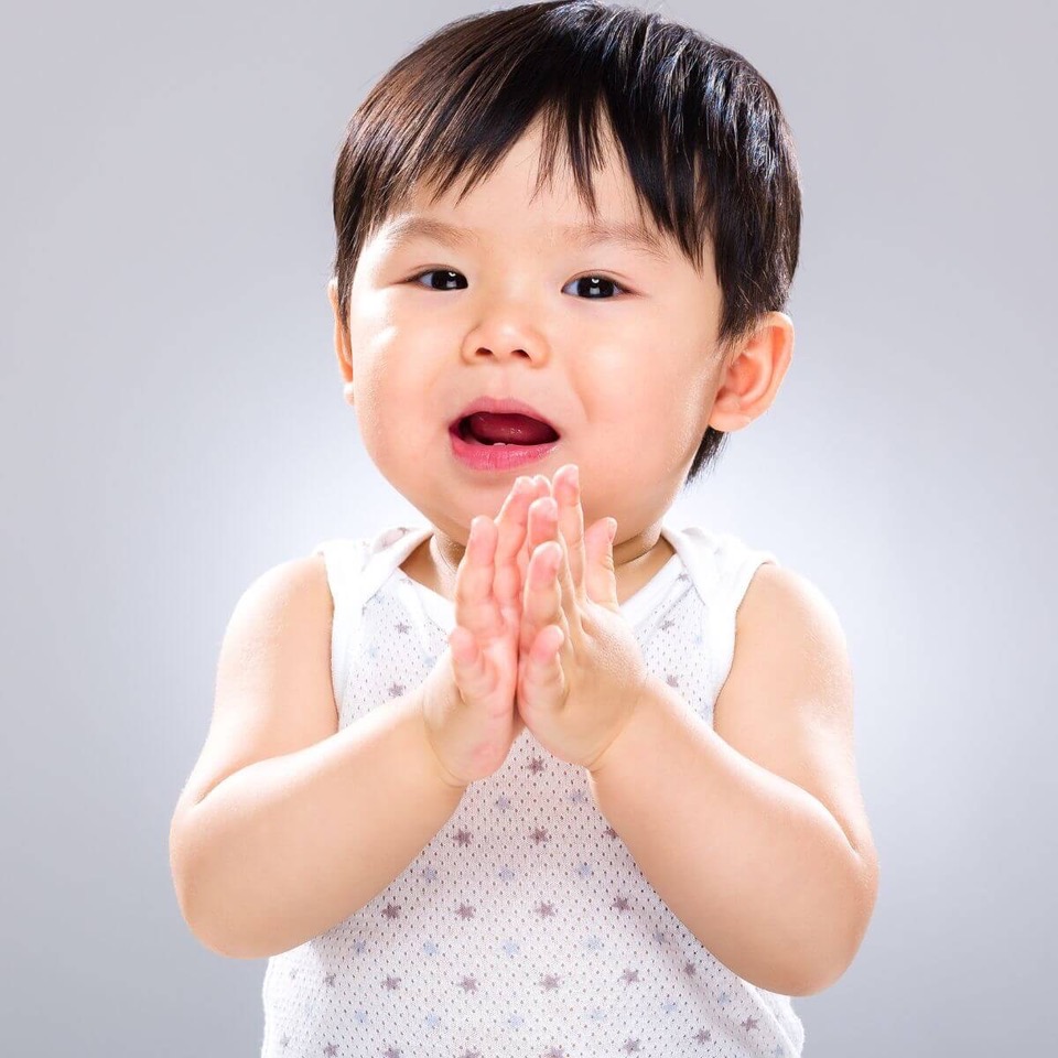A toddler clapping